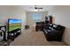 Home office with a large TV, desk and couch at 22446 E Russet Rd, Queen Creek, AZ 85142