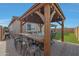 Outdoor patio with wood pergola, fire pit, and seating at 22446 E Russet Rd, Queen Creek, AZ 85142