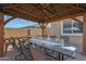 Relaxing outdoor patio with a fire pit and seating for six at 22446 E Russet Rd, Queen Creek, AZ 85142