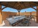 Covered patio with fire pit and seating area at 22446 E Russet Rd, Queen Creek, AZ 85142
