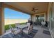 Covered patio, outdoor furniture and grassy backyard at 22446 E Russet Rd, Queen Creek, AZ 85142