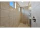 Large tiled shower with glass enclosure and window at 22446 E Russet Rd, Queen Creek, AZ 85142