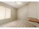 Bright bedroom with window, ceiling fan, and built-in desk at 3010 S Crawford Cir, Mesa, AZ 85212