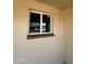 White framed window with sliding glass panels, offering natural light and backyard views at 3815 N 79Th Ave, Phoenix, AZ 85033