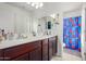 Double vanity bathroom with dark wood cabinets at 4102 S 186Th Ave, Goodyear, AZ 85338