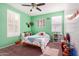 bedroom with green walls, toys, and bookshelves at 4102 S 186Th Ave, Goodyear, AZ 85338