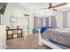 Spacious bedroom with a large bed, ceiling fan, and access to a hallway at 4102 S 186Th Ave, Goodyear, AZ 85338