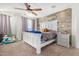 Bright bedroom with a ceiling fan, large bed, and wood-like accent wall at 4102 S 186Th Ave, Goodyear, AZ 85338