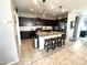 Modern kitchen featuring granite countertops, dark cabinetry, and an island with seating at 4102 S 186Th Ave, Goodyear, AZ 85338