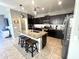 Spacious kitchen with granite island, dark cabinetry, and stainless steel appliances at 4102 S 186Th Ave, Goodyear, AZ 85338