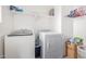 Bright laundry room with washer, dryer, and ample shelving at 4102 S 186Th Ave, Goodyear, AZ 85338