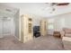 Living area with a sofa, entertainment center, and hallway at 4102 S 186Th Ave, Goodyear, AZ 85338