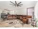 Living room with brown leather sectional and large rug at 4102 S 186Th Ave, Goodyear, AZ 85338