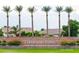 Cobblestone Farms community entrance with palm trees and stonework at 44023 W Stonecreek Rd, Maricopa, AZ 85139