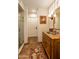 Bathroom with wood vanity, tiled floor and walk-in shower at 6701 N Scottsdale Rd # 20, Scottsdale, AZ 85250