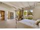 Main bedroom with high ceilings, metal bed frame, and access to private patio at 6701 N Scottsdale Rd # 20, Scottsdale, AZ 85250