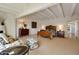Spacious bedroom with wooden bed frame, sitting area, and high ceilings at 6701 N Scottsdale Rd # 20, Scottsdale, AZ 85250