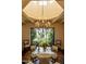 Elegant dining room features a glass-top table, chandelier, and ornate metal screen at 6701 N Scottsdale Rd # 20, Scottsdale, AZ 85250