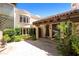 Charming courtyard entry with a stone patio and lush landscaping at 6701 N Scottsdale Rd # 20, Scottsdale, AZ 85250