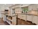 Spacious kitchen with white cabinets, island, and terracotta tile floor at 6701 N Scottsdale Rd # 20, Scottsdale, AZ 85250
