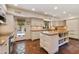 Bright kitchen boasts white cabinets, an island, and access to a patio at 6701 N Scottsdale Rd # 20, Scottsdale, AZ 85250