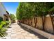 Stone pathway lined with trees and greenery at 6701 N Scottsdale Rd # 20, Scottsdale, AZ 85250