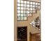 Staircase with glass and metal accents, built-in wine rack below at 6701 N Scottsdale Rd # 20, Scottsdale, AZ 85250