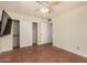 Bedroom with tile floors, double door closet, and ceiling fan at 7015 W Cherry Hills Dr, Peoria, AZ 85345