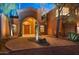 Elegant entryway with arched entry, and desert landscaping at 9112 E Sands Dr, Scottsdale, AZ 85255