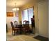 Simple dining area with a round table and four chairs near entrance at 9616 W Mountain View Rd # A, Peoria, AZ 85345