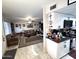 View of kitchen and living room with white cabinets and tile flooring at 9616 W Mountain View Rd # A, Peoria, AZ 85345