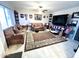 Spacious living room featuring two sofas, a large TV, and decorative rug at 9616 W Mountain View Rd # A, Peoria, AZ 85345