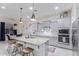 Modern kitchen with gray cabinets, granite island, and stainless steel appliances at 12170 S 184Th Ave, Goodyear, AZ 85338