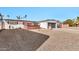 Front yard view of the house with gravel and a wooden fence at 12414 N 33Rd St, Phoenix, AZ 85032