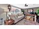 Cozy living room with a sofa, workspace, and large windows at 12414 N 33Rd St, Phoenix, AZ 85032