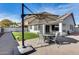 Backyard with patio furniture, artificial turf, and a view of the house at 15547 W Magnolia St, Goodyear, AZ 85338
