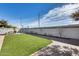 Landscaped backyard with artificial turf and a patio area at 15547 W Magnolia St, Goodyear, AZ 85338