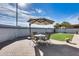Artificial turf backyard with patio furniture and umbrella at 15547 W Magnolia St, Goodyear, AZ 85338