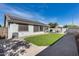 Landscaped backyard with artificial turf and solar panels at 15547 W Magnolia St, Goodyear, AZ 85338