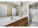 Bathroom with double vanity and shower/tub combo at 15547 W Magnolia St, Goodyear, AZ 85338