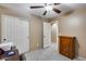 Bedroom with double door closet and ceiling fan at 15547 W Magnolia St, Goodyear, AZ 85338