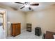 Bright bedroom with ceiling fan, window, and ample closet space at 15547 W Magnolia St, Goodyear, AZ 85338