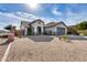 Single-story home with gray garage door and desert landscaping at 15547 W Magnolia St, Goodyear, AZ 85338
