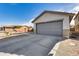 Attached gray garage with a concrete driveway at 15547 W Magnolia St, Goodyear, AZ 85338