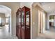Hallway with a wooden china cabinet and access to bedrooms and bath at 15547 W Magnolia St, Goodyear, AZ 85338