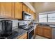 Kitchen boasting granite countertops and ample wood cabinetry at 15547 W Magnolia St, Goodyear, AZ 85338