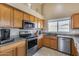 Well-equipped kitchen with stainless steel appliances and granite countertops at 15547 W Magnolia St, Goodyear, AZ 85338