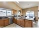 Kitchen boasts granite countertops, ample cabinetry, and an island at 15547 W Magnolia St, Goodyear, AZ 85338