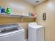 Laundry room with washer, dryer, and shelving at 15547 W Magnolia St, Goodyear, AZ 85338