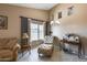Relaxing living room area with a chaise lounge and decorative accents at 15547 W Magnolia St, Goodyear, AZ 85338
